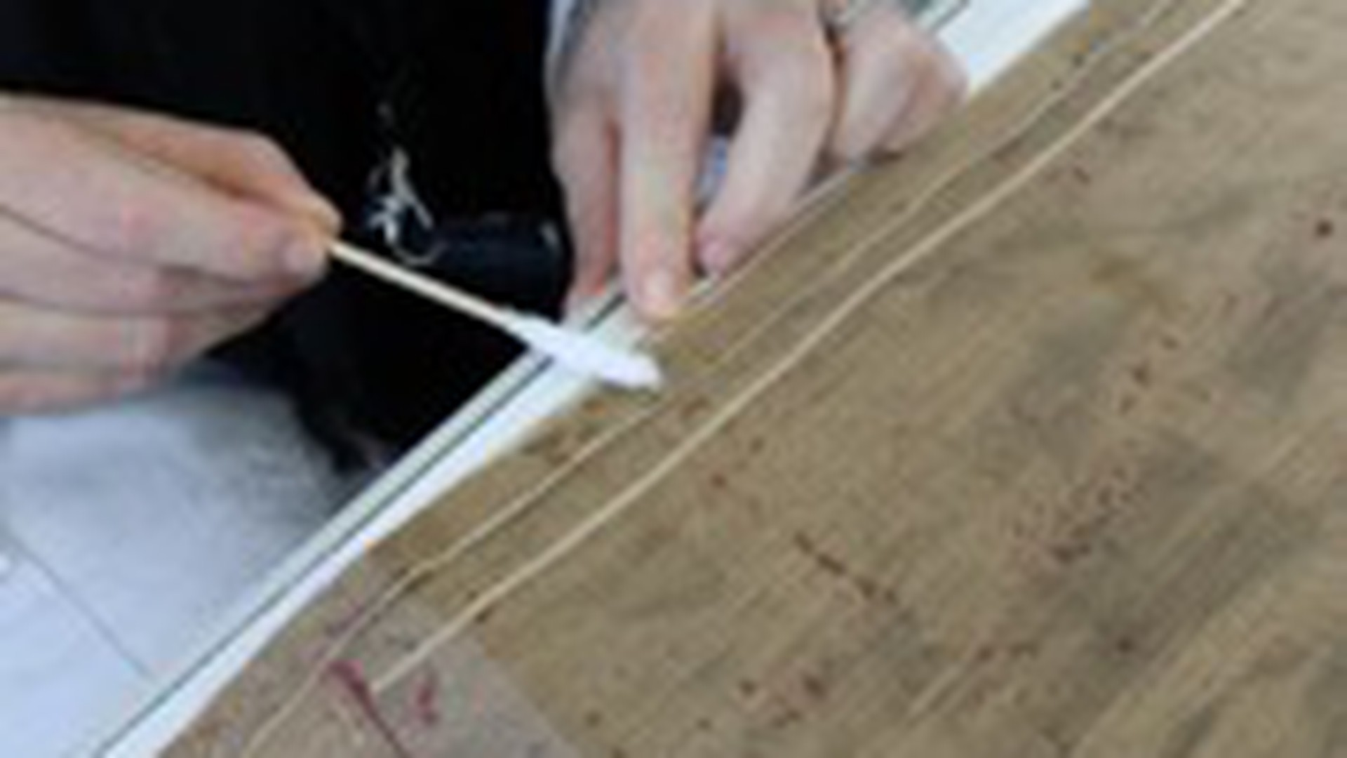 Removal of the small fragments of adhesive that are on the red lining
